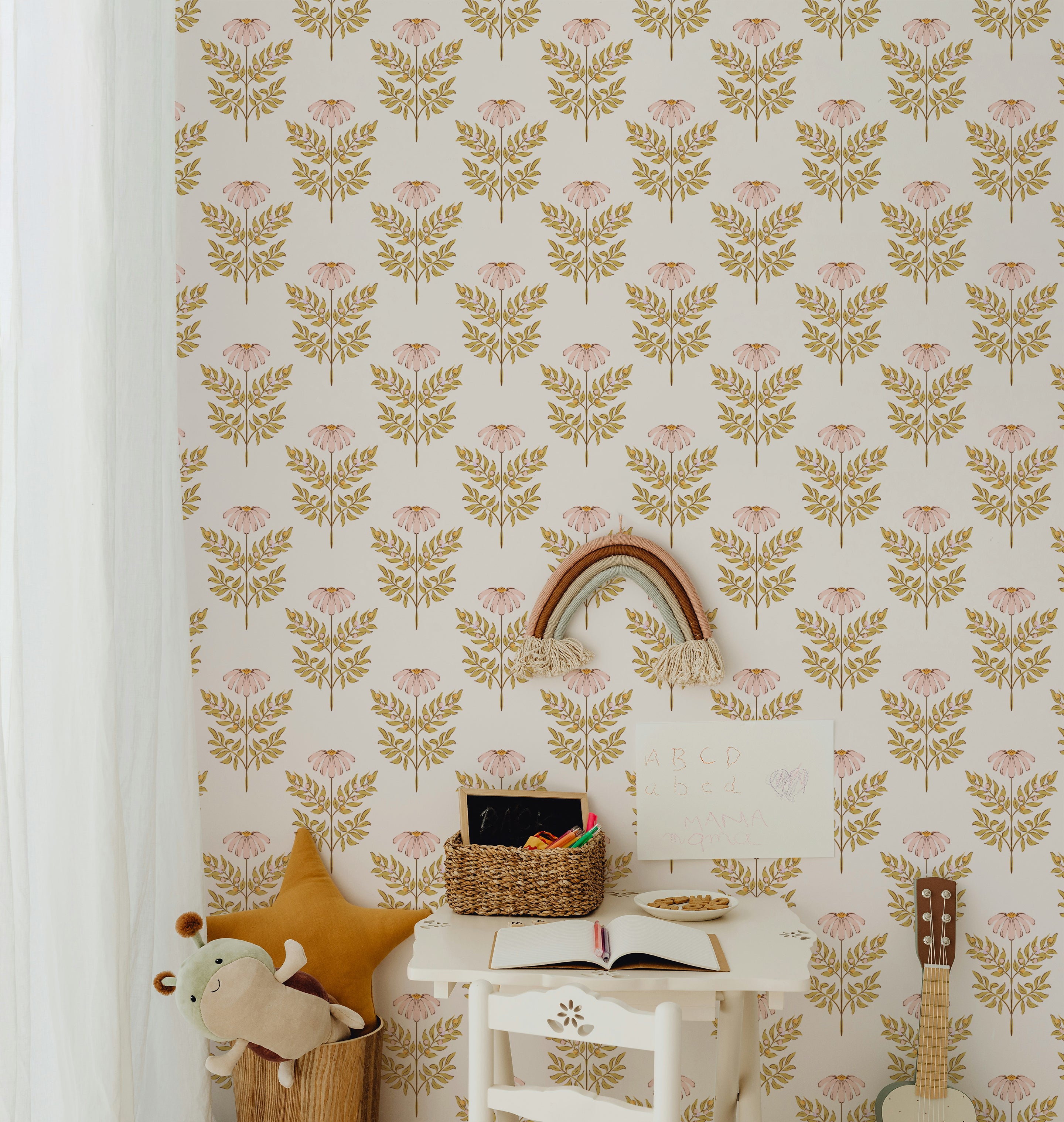 A charming children's study area enhanced by the Ditsy Daisy Wallpaper, featuring pink floral motifs and golden leaves on a soft background. The space is equipped with a small white desk, colorful children’s books, and playful decor, fostering a creative and cheerful learning environment.