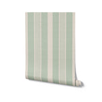 Rolled view of Ticking Fabrics 12 Wallpaper displaying alternating wide stripes in sage green and cream. The wallpaper's hessian-like texture offers a tactile feel, making it an excellent choice for adding depth and character to interiors
