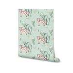 A roll of Watercolor Farm Animals III wallpaper with a delightful and soothing pattern of cows, trees, and nature accents, rendered in soft watercolors on a mint green base, perfect for a playful yet peaceful nursery setup