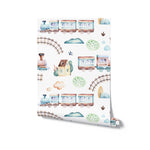 A roll of 'Trains and Planes Kids Wallpaper' unrolled slightly to show its detailed pattern of trains, planes, and charming landscape elements like houses and trees, rendered in soft watercolor pastels. The wallpaper is perfect for adding a touch of adventure and creativity to any child's room.