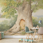 A children's room featuring a large mural of a tree with a door in its trunk, styled as Winnie the Pooh's house, surrounded by toys and children's furniture under a canopy of green leaves.