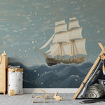 Child's bedroom with nautical theme featuring a ship sailing mural on the wall, a tent play area, and wooden toys.