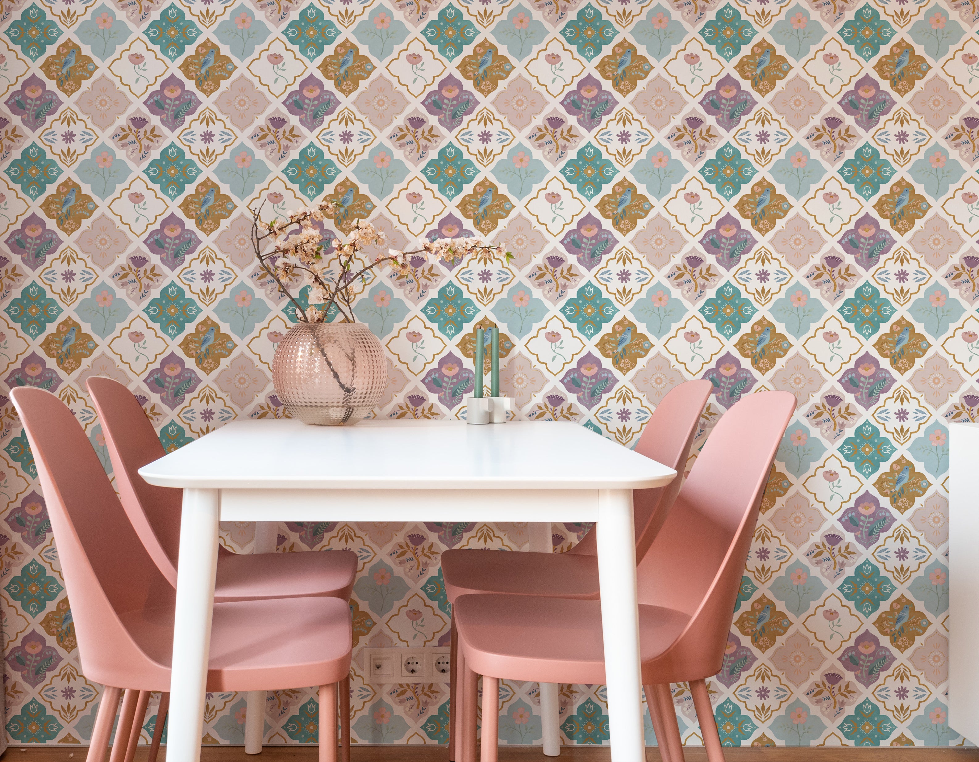 Modern dining area showcasing walls adorned with floral mosaic wallpaper, presenting a symmetrical design of blooms and avian motifs in soft hues, complemented by minimalist furniture.