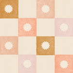 Close-up of the Coralie Wallpaper displaying a watercolor-style grid pattern in soft peach, beige, and gold hues, each square featuring a subtle sunburst design that adds a touch of elegance