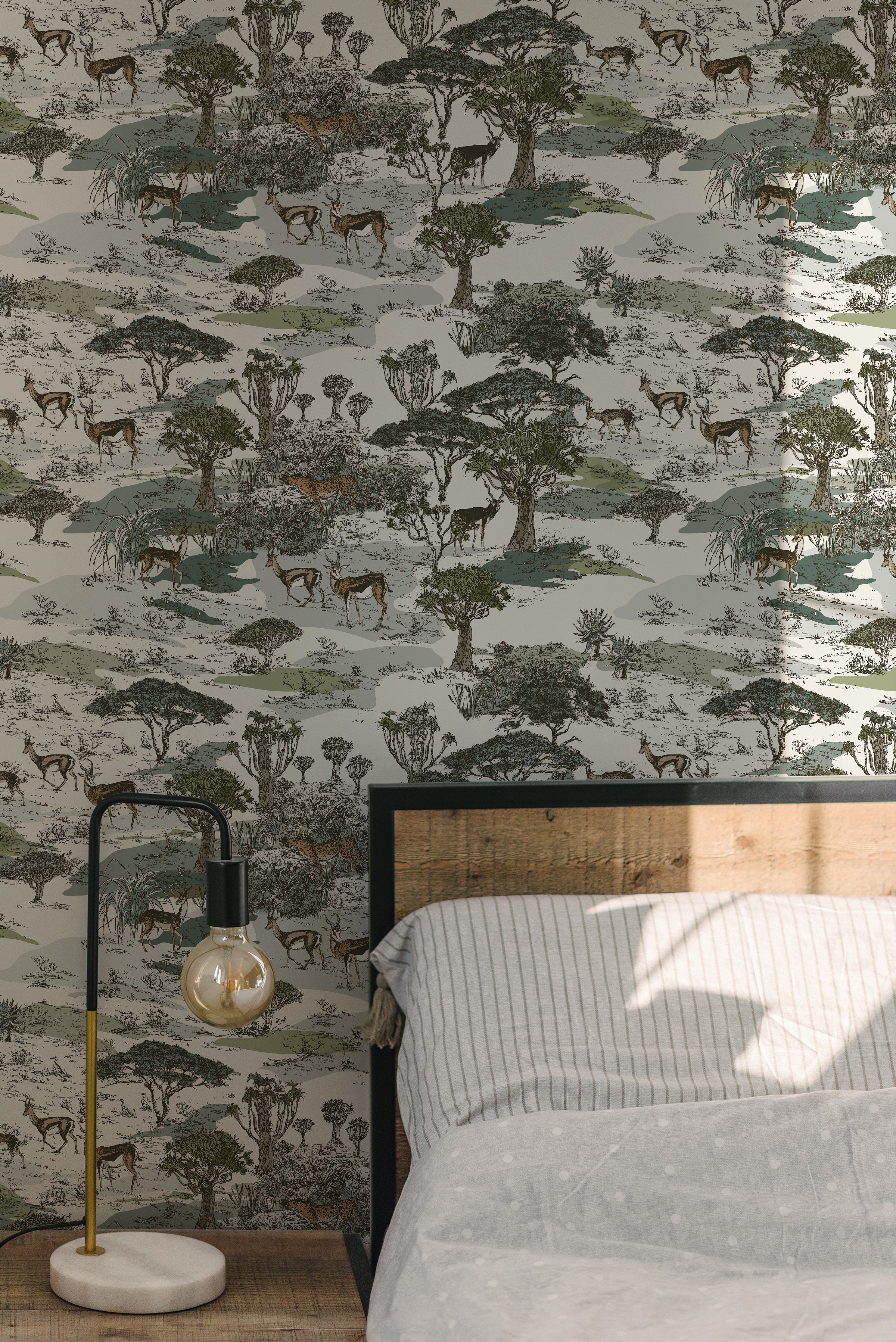 A bedroom showcasing the Serengeti Wallpaper as a feature wall behind a modern bed. The wallpaper’s intricate pattern of African wildlife and flora adds a dynamic and naturalistic element to the room, complemented by a simple bed frame and soft bedding