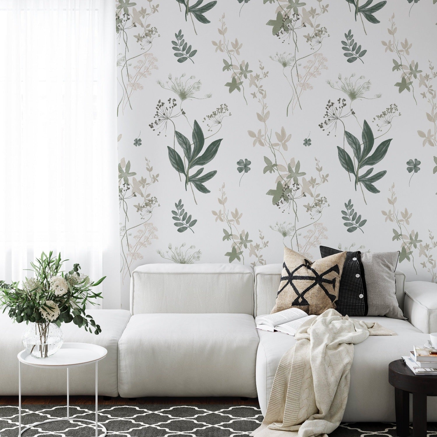 An elegant living room showcasing the "Aerie Floral IV" wallpaper, which adds a touch of nature’s serenity to the interior design. The floral pattern creates a soothing backdrop for the modern white sofa, accented with chic decorative pillows, underlining the room's sophisticated yet cozy atmosphere.