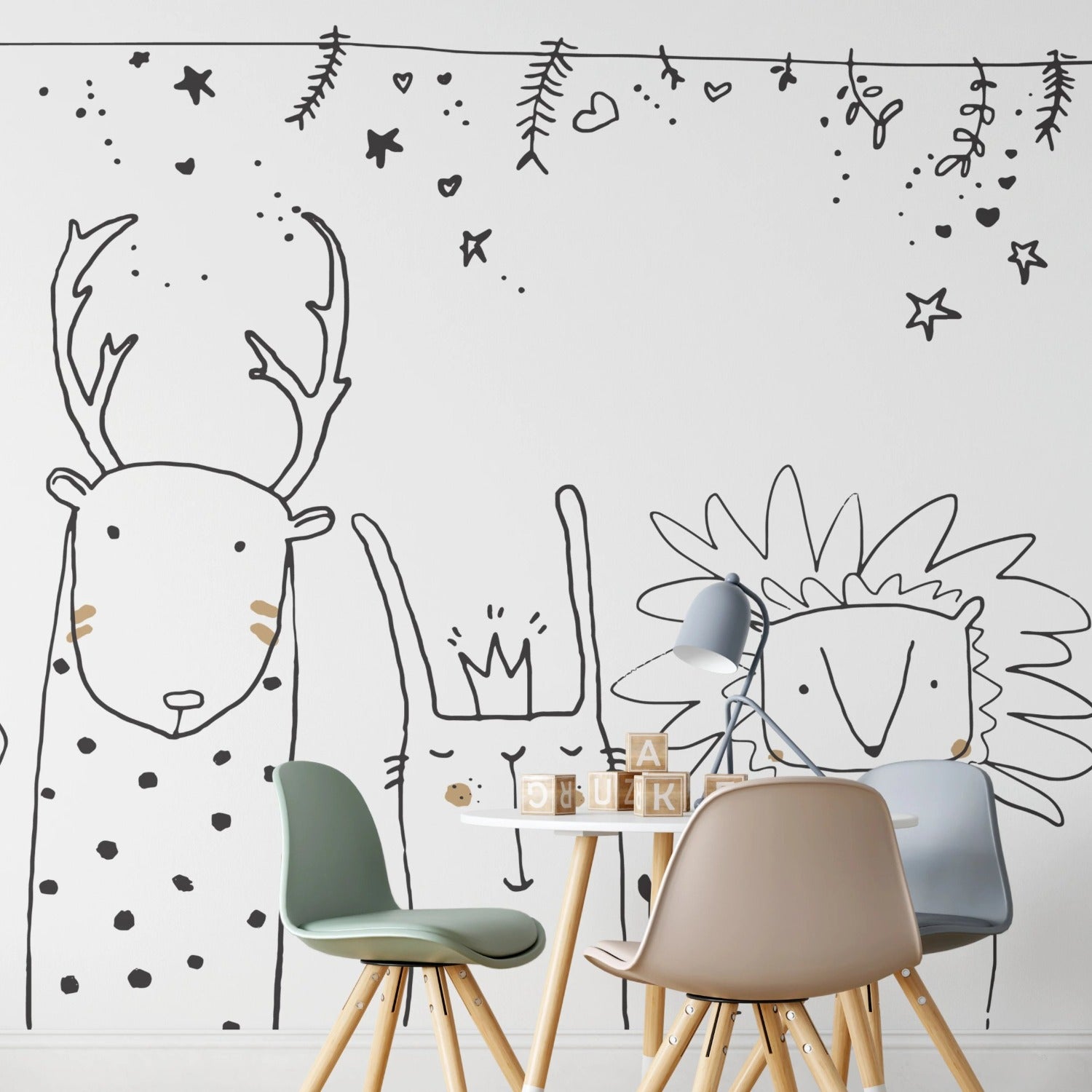 Scandinavian style children's room with large animal drawings wallpaper including a bear, deer, and rabbit