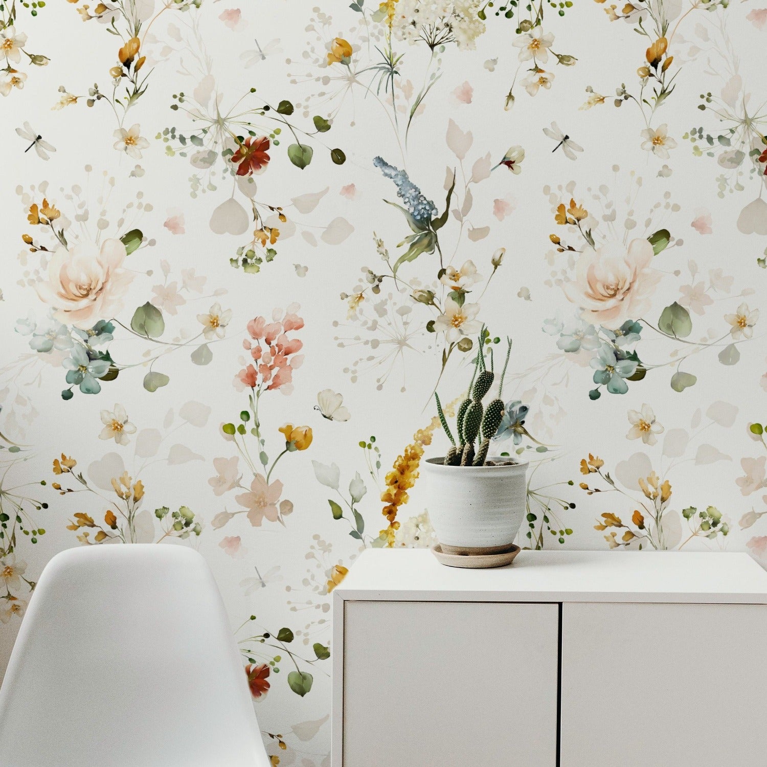 A cozy and modern corner with the Fiori Wallpaper serving as a backdrop for a minimalist workspace, where the pastel floral print complements a sleek white desk and a modern chair, enhancing the room's charm and warmth