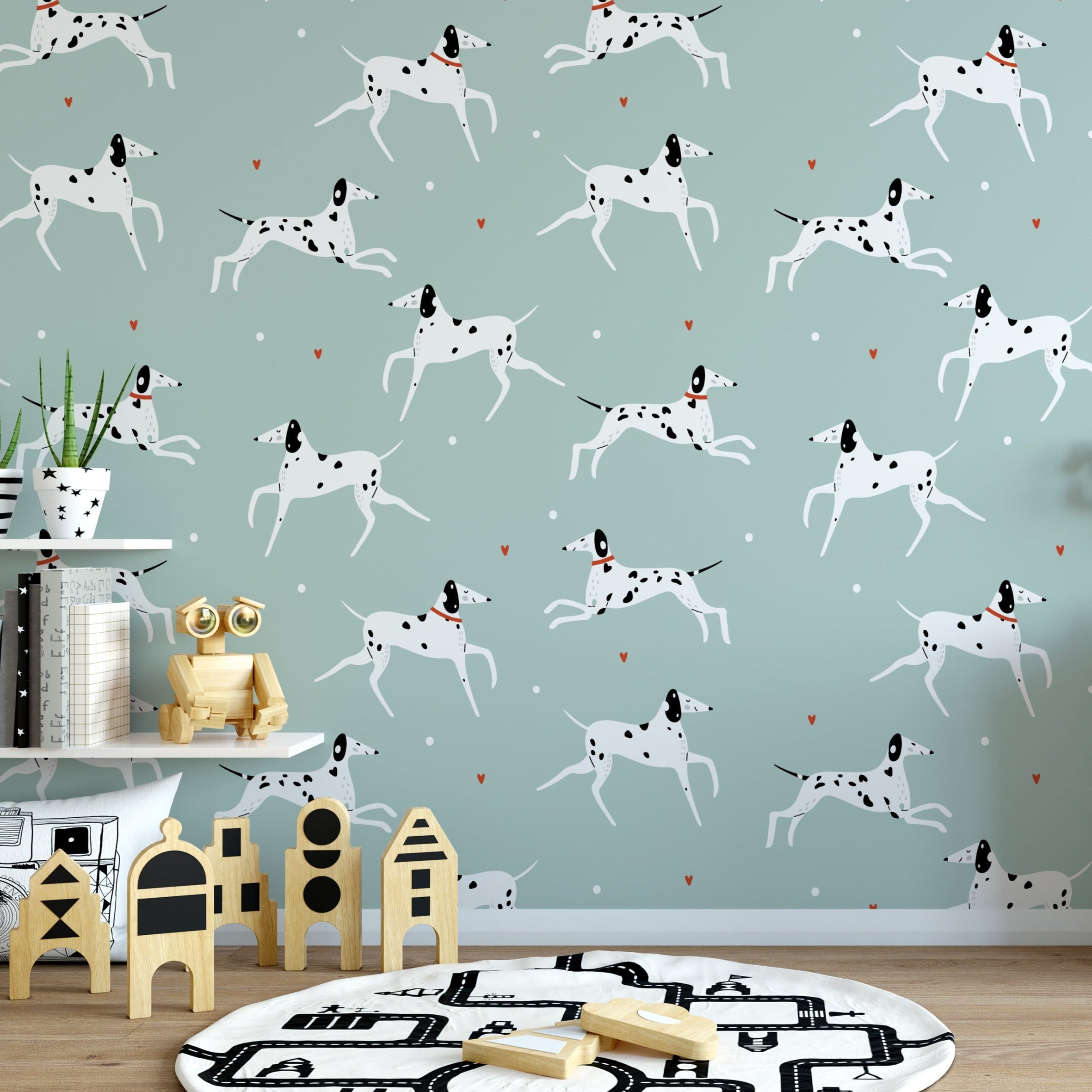 Children's play area decorated with 'Let's Pawty! Kids Wallpaper', showcasing animated white Dalmatian dogs with black spots, frolicking across a mint green backdrop. The room includes wooden children’s toys and a plush seating area, creating a lively and engaging environment