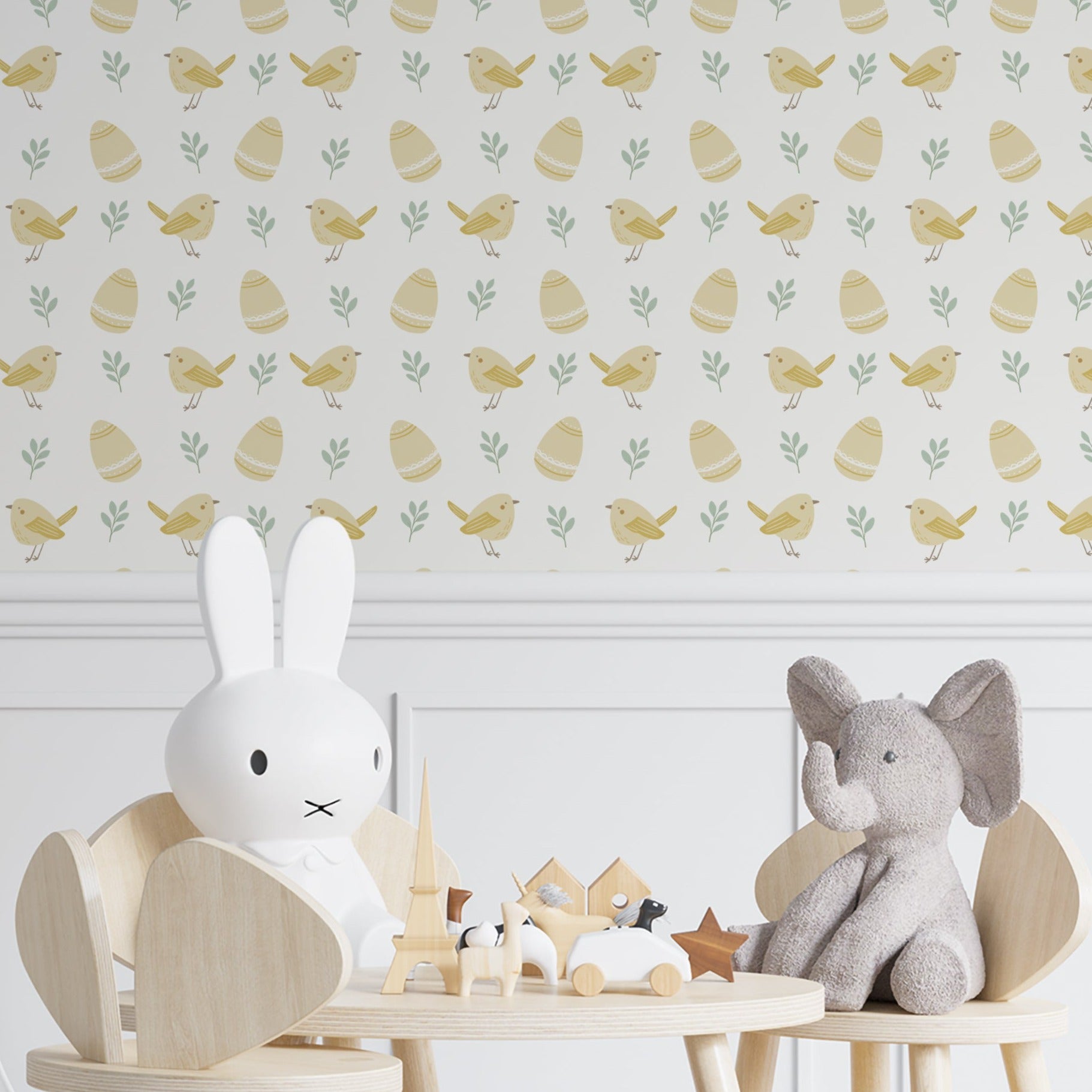 Children's room with a wall covered in 'Nursery Baby Chick Wallpaper' showing a pattern of yellow chicks and Easter eggs. Decor includes a wooden chair with a rabbit figure and a toy elephant on the table
