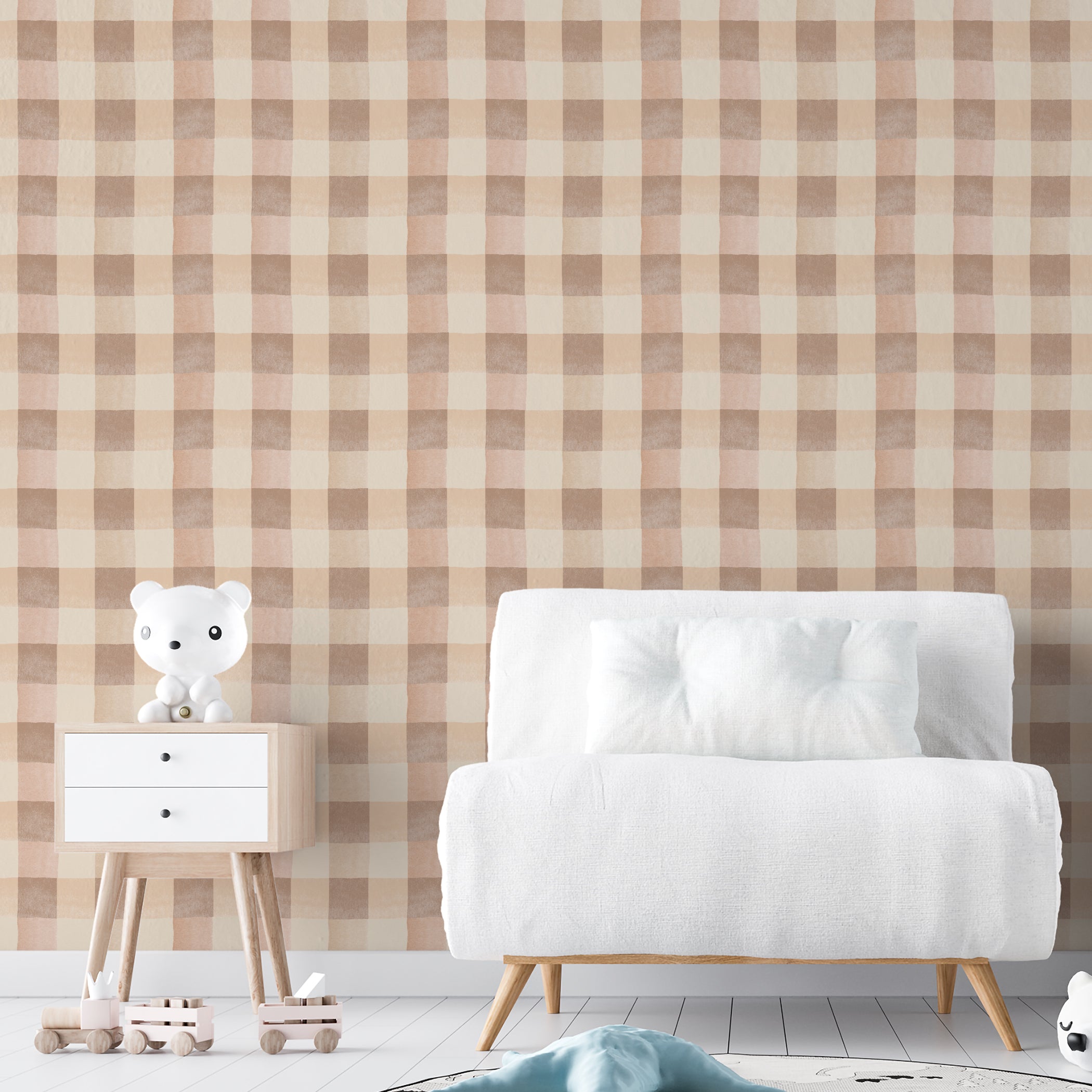 A contemporary room setting featuring Camille Wallpaper with a checkered pattern in pastel beige and cream. The room includes a modern white sofa and a wooden table with a cute white bear figurine, creating a calm and inviting atmosphere