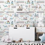 Close-up view of the 'Trains and Planes Kids Wallpaper II' showcasing a delightful scene with vintage-style trains, propeller planes, charming houses, and lush landscapes. The pattern is rendered in soft watercolors, featuring serene blues, greens, and earth tones, perfect for nurturing a child's imagination