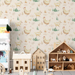 A child's playroom featuring walls adorned with a watercolor wallpaper that displays a pattern of chickens, chicks, ducks, and ducklings in a pastoral scene. The room includes wooden toys and a house-shaped shelf filled with various playful items.