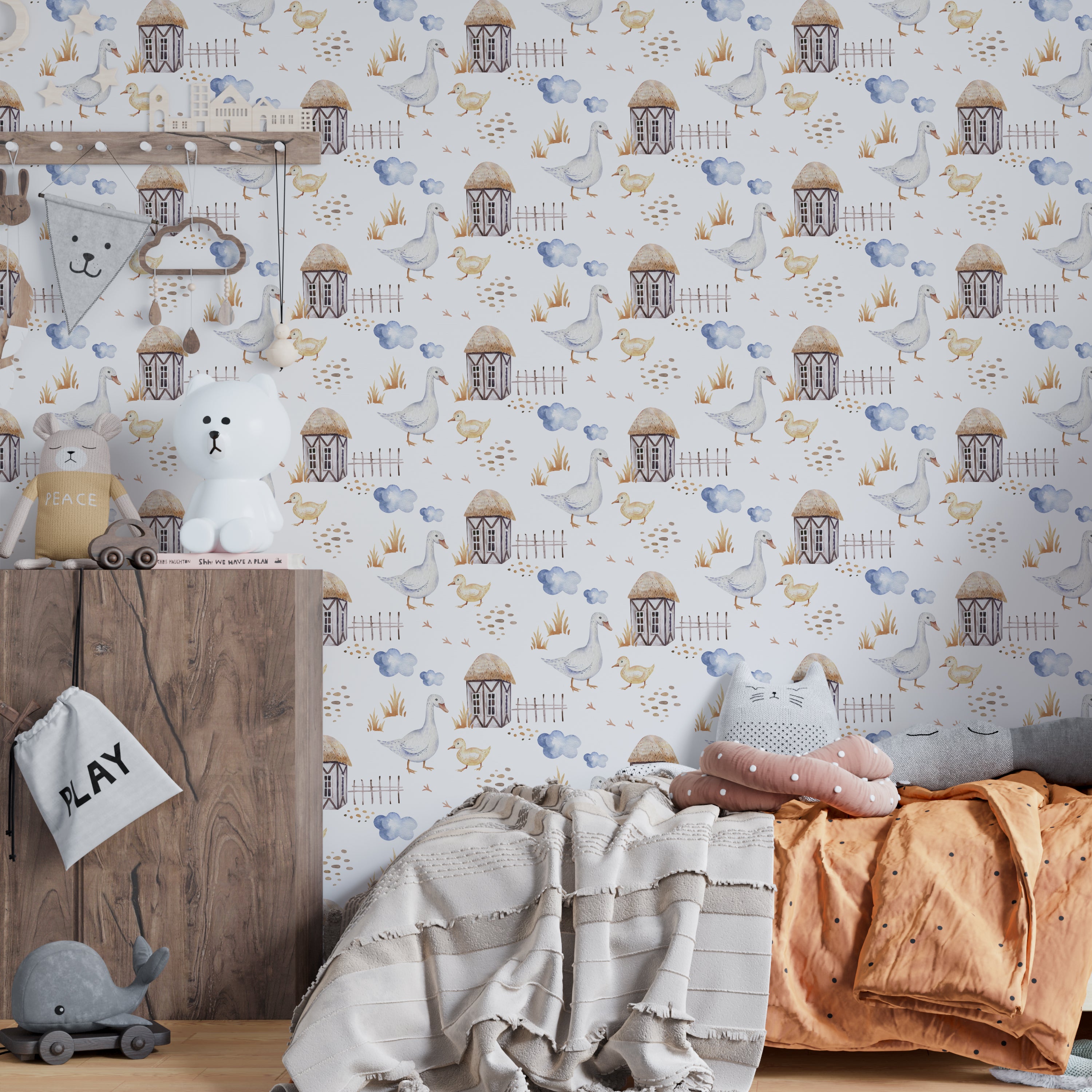 A child's nursery room decorated with 'Watercolor Farm Animals VI' wallpaper displaying a peaceful farm setting with geese and chicks near quaint farmhouses, enhancing the room's cozy and pastoral ambiance