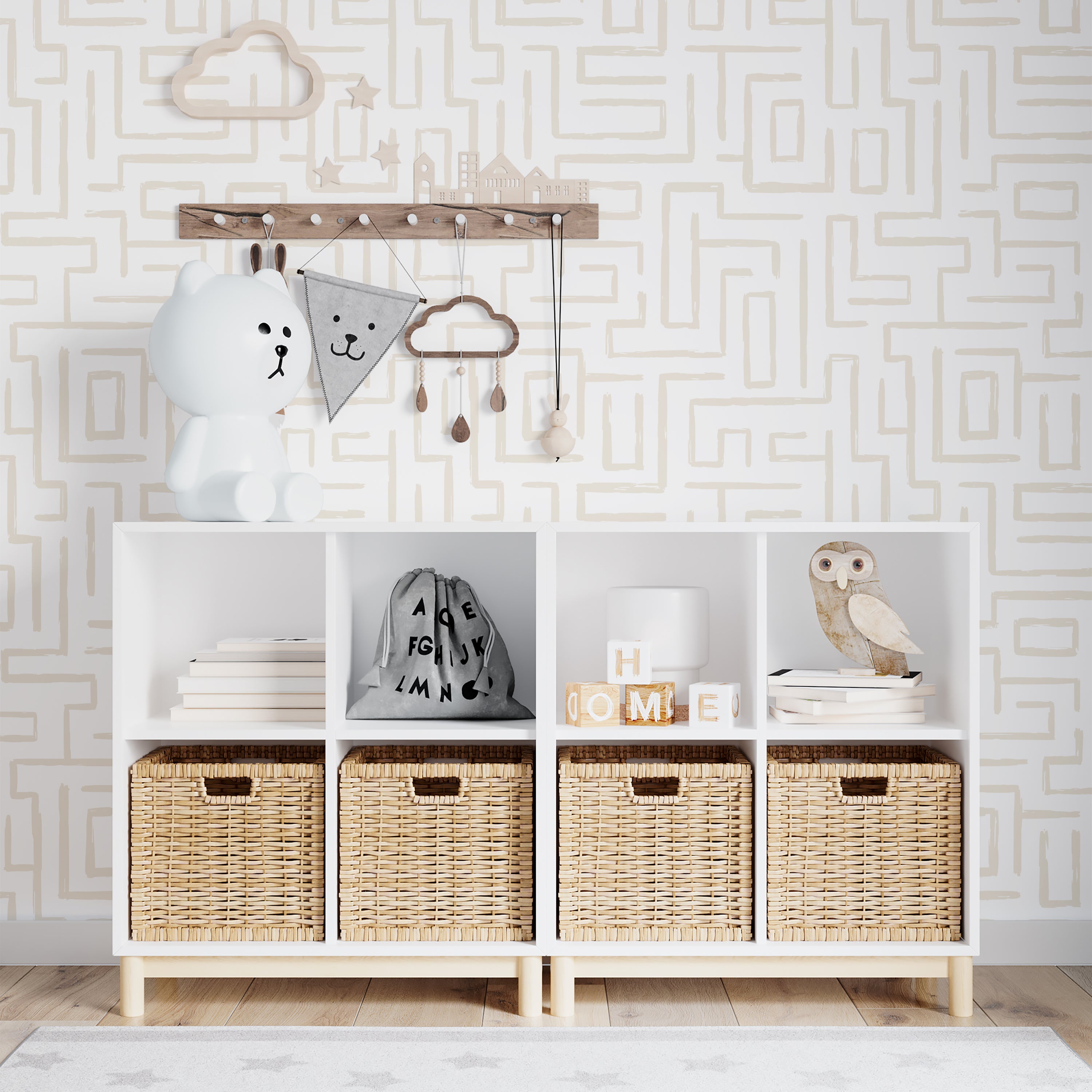 A stylish nursery room wall covered with Organic Wallpaper 19 Ecru, featuring an intricate maze pattern in a gentle ecru shade. The room is accessorized with a children's shelf displaying toys and decorative items, enhancing a playful yet sophisticated space.