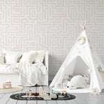 A child's nursery room wall covered with Organic Wallpaper 19, displaying a maze-like pink line pattern. The room includes a white play tent adorned with plush toys and star decorations, creating a playful and inviting atmosphere