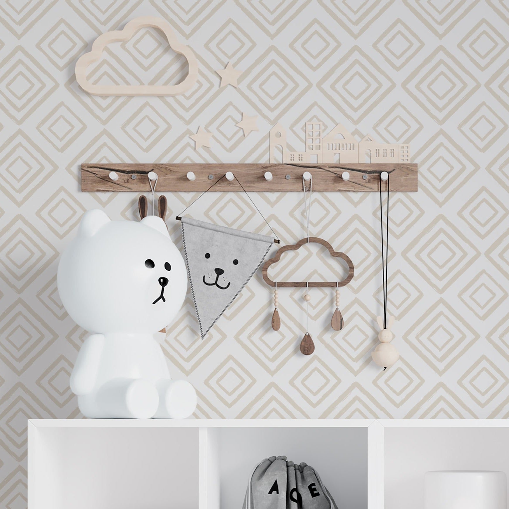A nursery room decorated with Organic Shape Wallpaper 18 on the walls, featuring a geometric pattern in taupe. The room includes a white storage unit with wicker baskets and playful children's accessories, creating a stylish yet functional space.