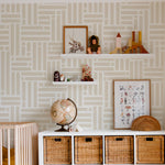 A child's room decorated with Organic Wallpaper 22, featuring an elegant geometric pattern in beige. The room includes playful shelving units and a variety of children's toys, creating a stylish and functional environment