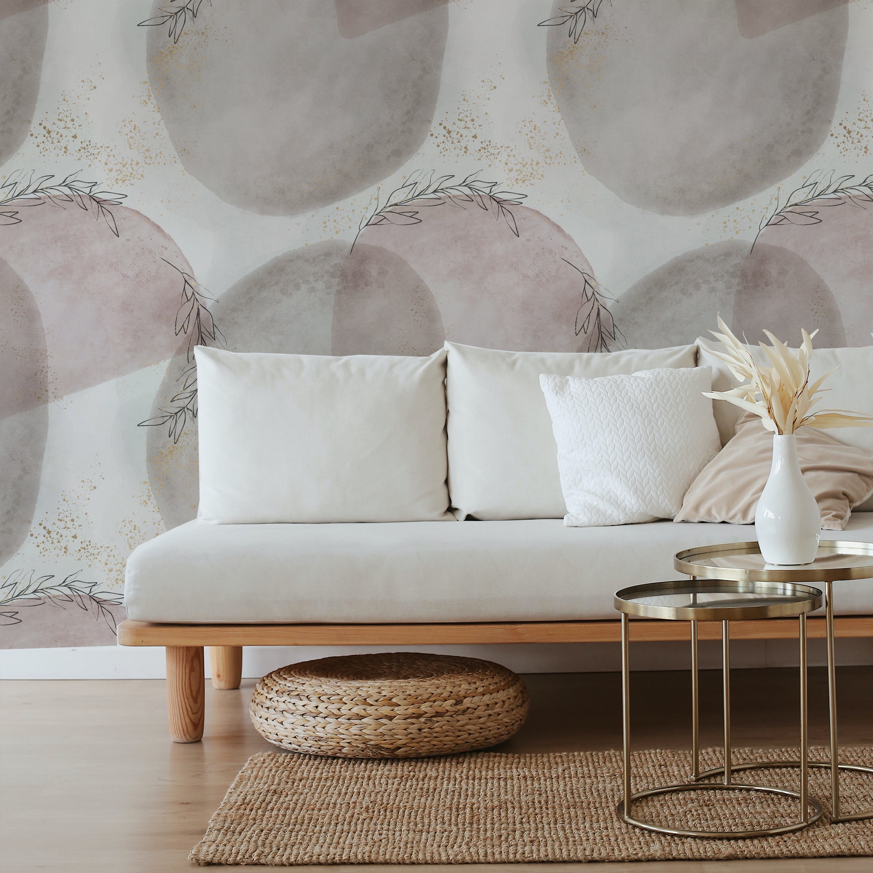 A contemporary living room beautifully accented with Shimmer and Paint Wallpaper. The wallpaper's gentle pink and grey tones complemented by golden speckles create a warm and inviting ambiance, perfect for a relaxing and stylish environment.
