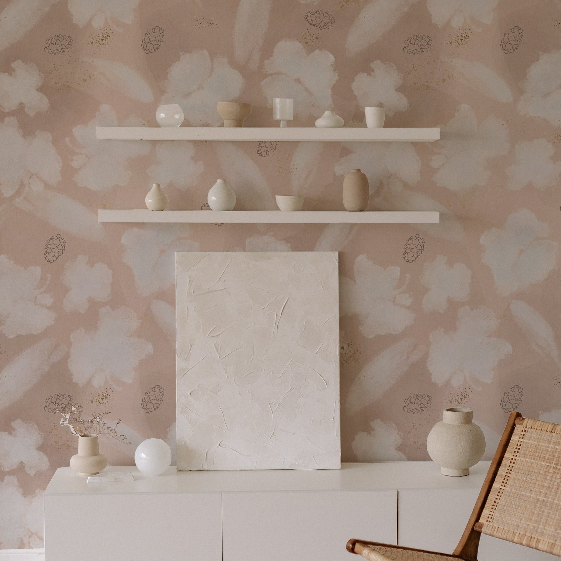 A modern living space showcasing the Shimmer and Floral Wallpaper, with its serene pattern of large white blossoms and golden specks, providing a backdrop for a minimalist white credenza and decorative ceramics, enhancing the room's contemporary elegance.