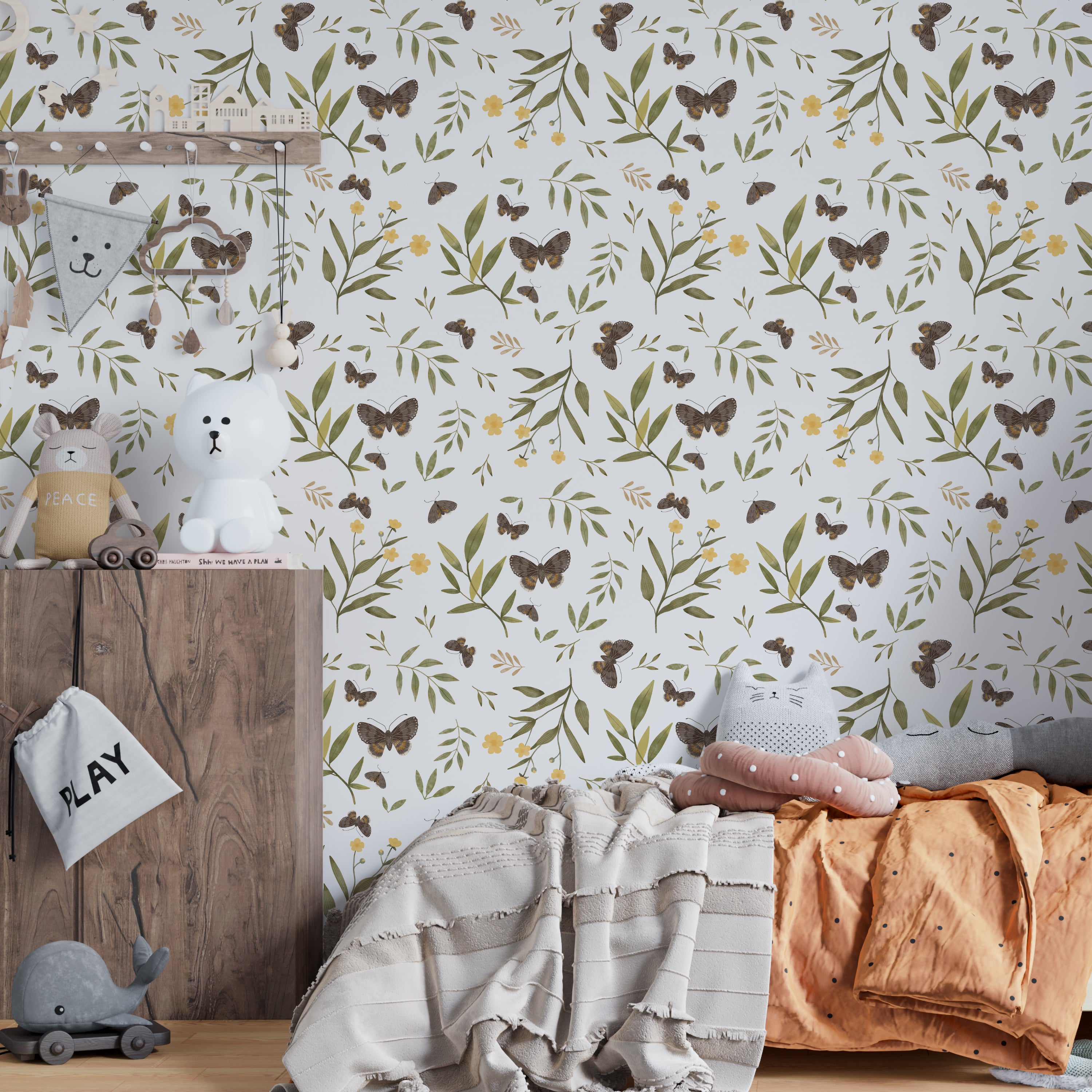 Children's room adorned with Forest Moth Wallpaper, showing a vibrant pattern of moths, leaves, and flowers that creates a stimulating and educational environment. The room is equipped with soft toys and playful decor, ideal for a nurturing and imaginative space