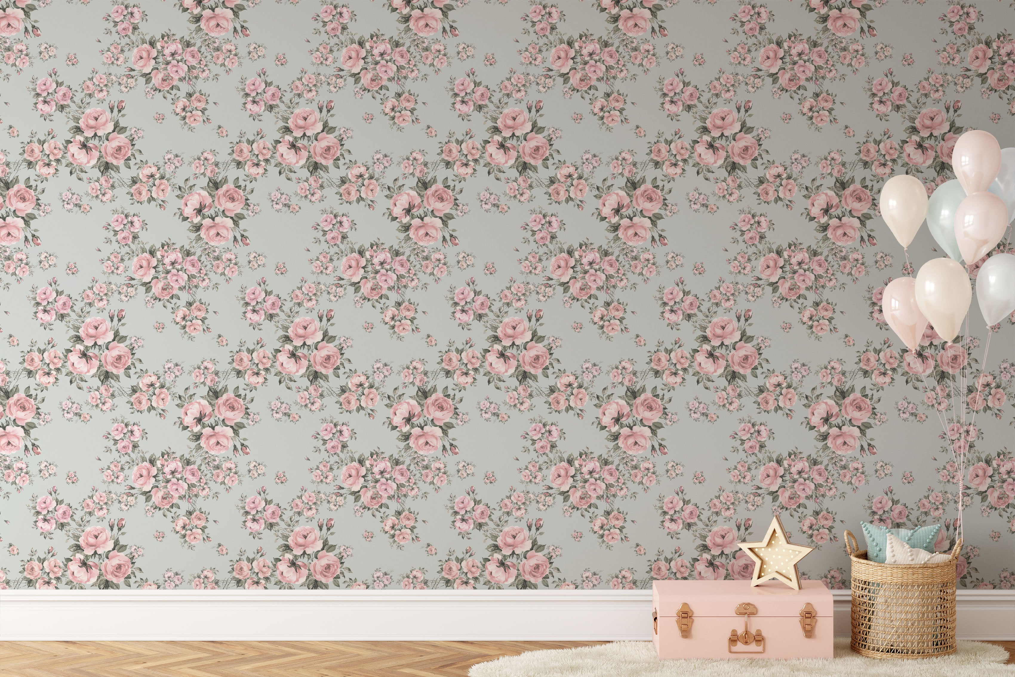 A stylish living area with Rose Bouquet Wallpaper II, featuring pink roses and green leaves on a light blue background. The decor includes a wicker basket, balloons, and a pink toy chest.