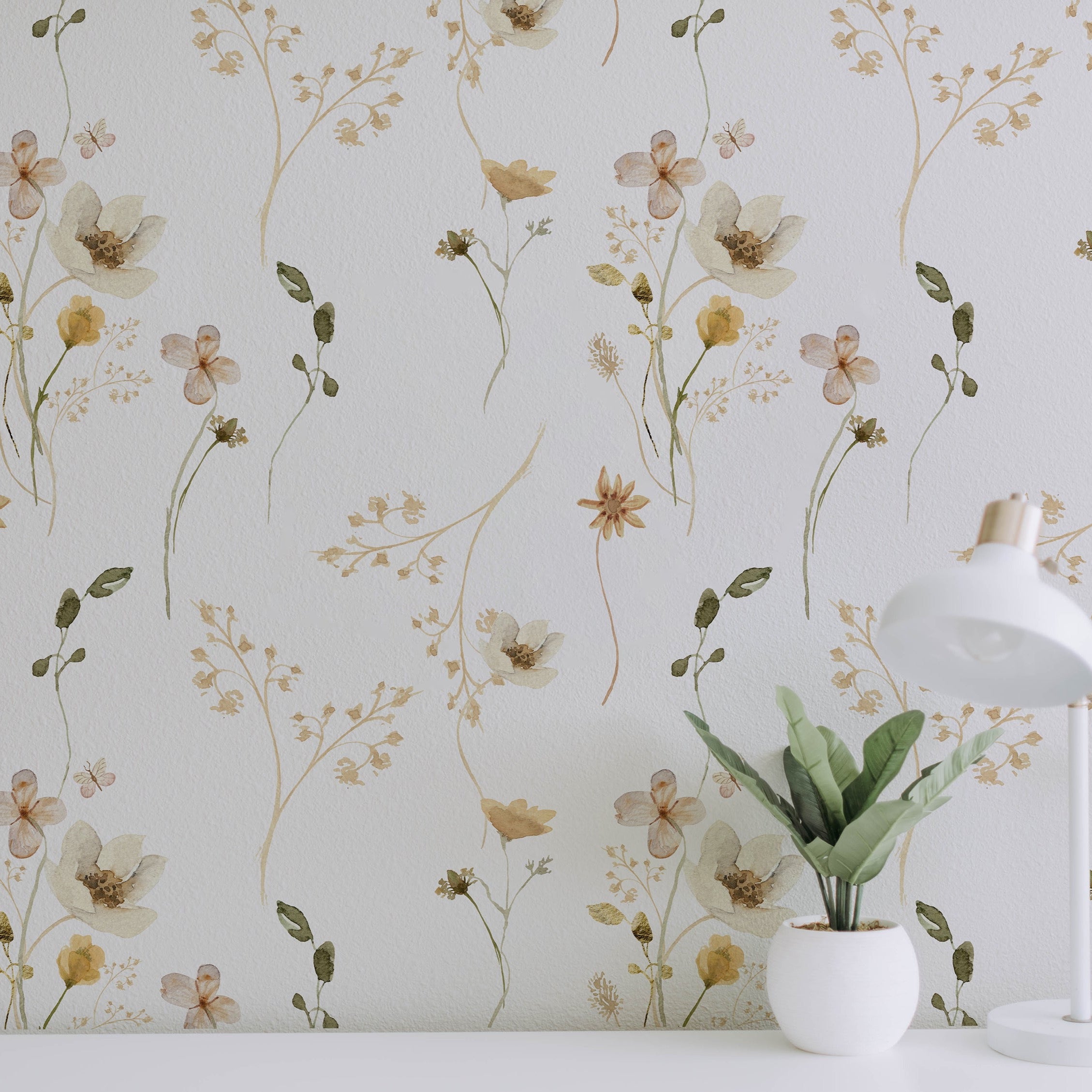 A modern home office corner is accented with the Delicate Floral Wallpaper II. The wallpaper's subtle floral design adds a touch of nature's finesse, harmonizing with a chic desk lamp and a potted plant for a workspace that’s both stylish and soothing.