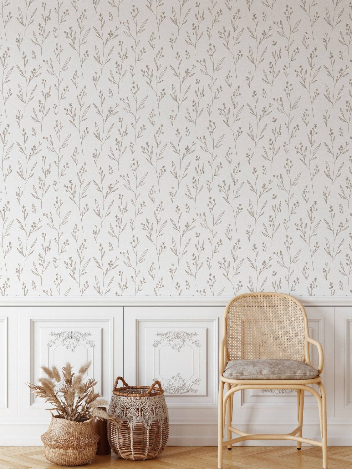  light-filled classic room featuring beige dainty minimal floral wallpaper, with elegant white wainscoting below and decorative frames, complemented by a rattan chair and woven baskets
