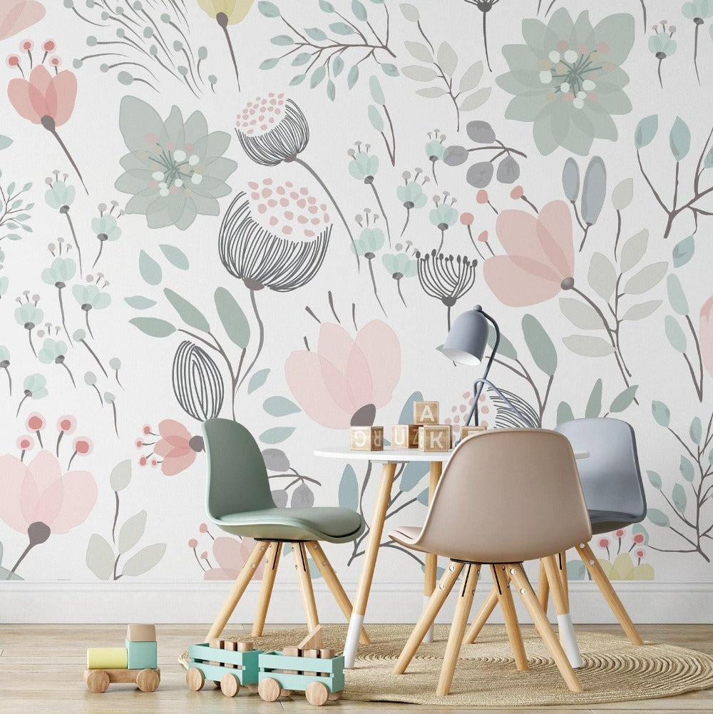 A playful and creative children's workspace with a whimsical floral wallpaper in pastel tones, featuring stylized flowers and leaves, accompanied by modern children's furniture including a small wooden desk and two chairs in muted green and beige