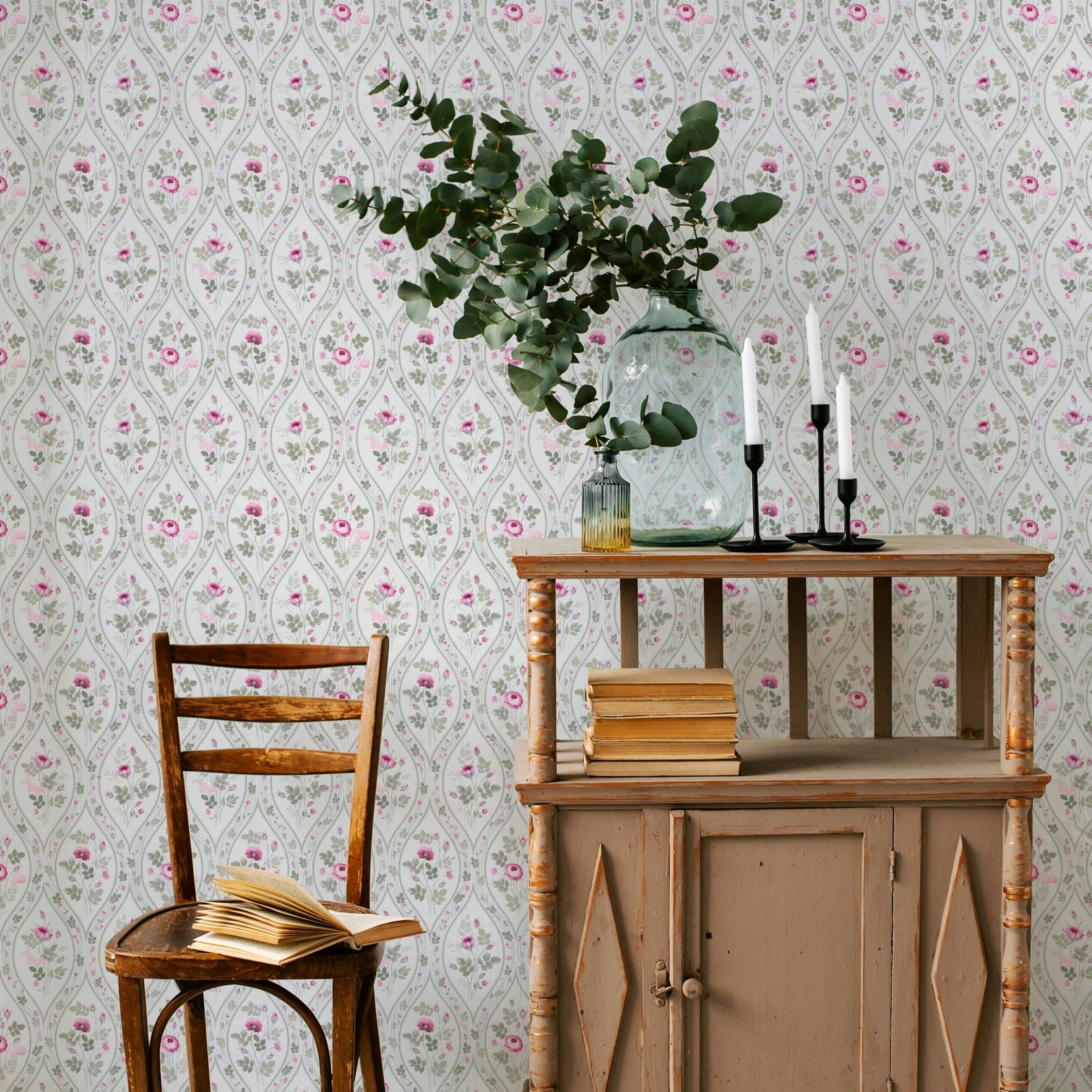 A traditional interior setting showcasing the Vintage Charm Wallpaper, where subtle gray teardrops form a classic backdrop to pink roses and green foliage. The vintage furniture and rustic décor enhance the timeless appeal of the wallpaper, creating a cozy and nostalgic space.