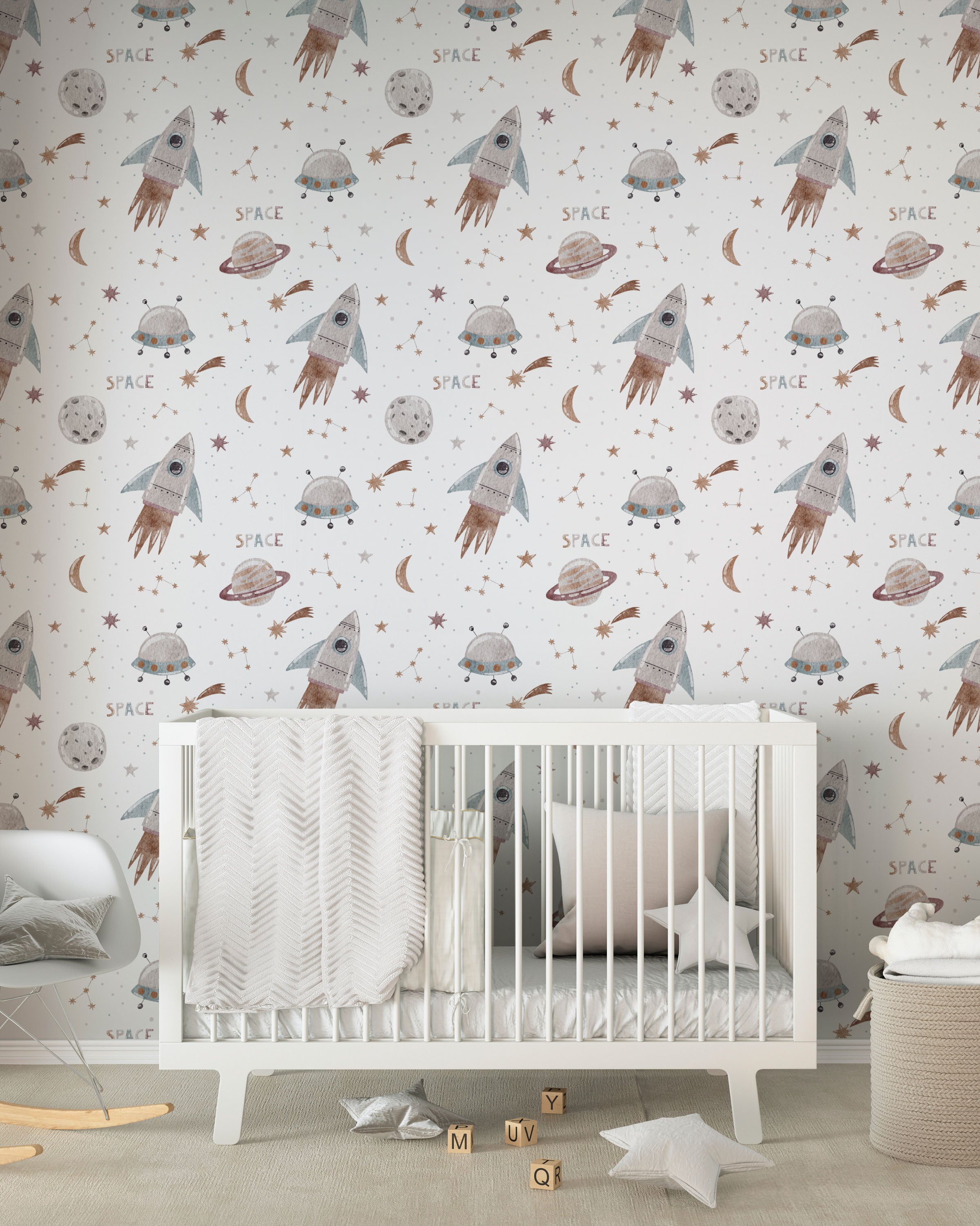 A charming nursery featuring the Space Craze Wallpaper, decorated with whimsical illustrations of rockets, UFOs, planets, and stars on a light background. The room includes a white crib draped with a soft, textured blanket, creating a playful yet serene space for a child.