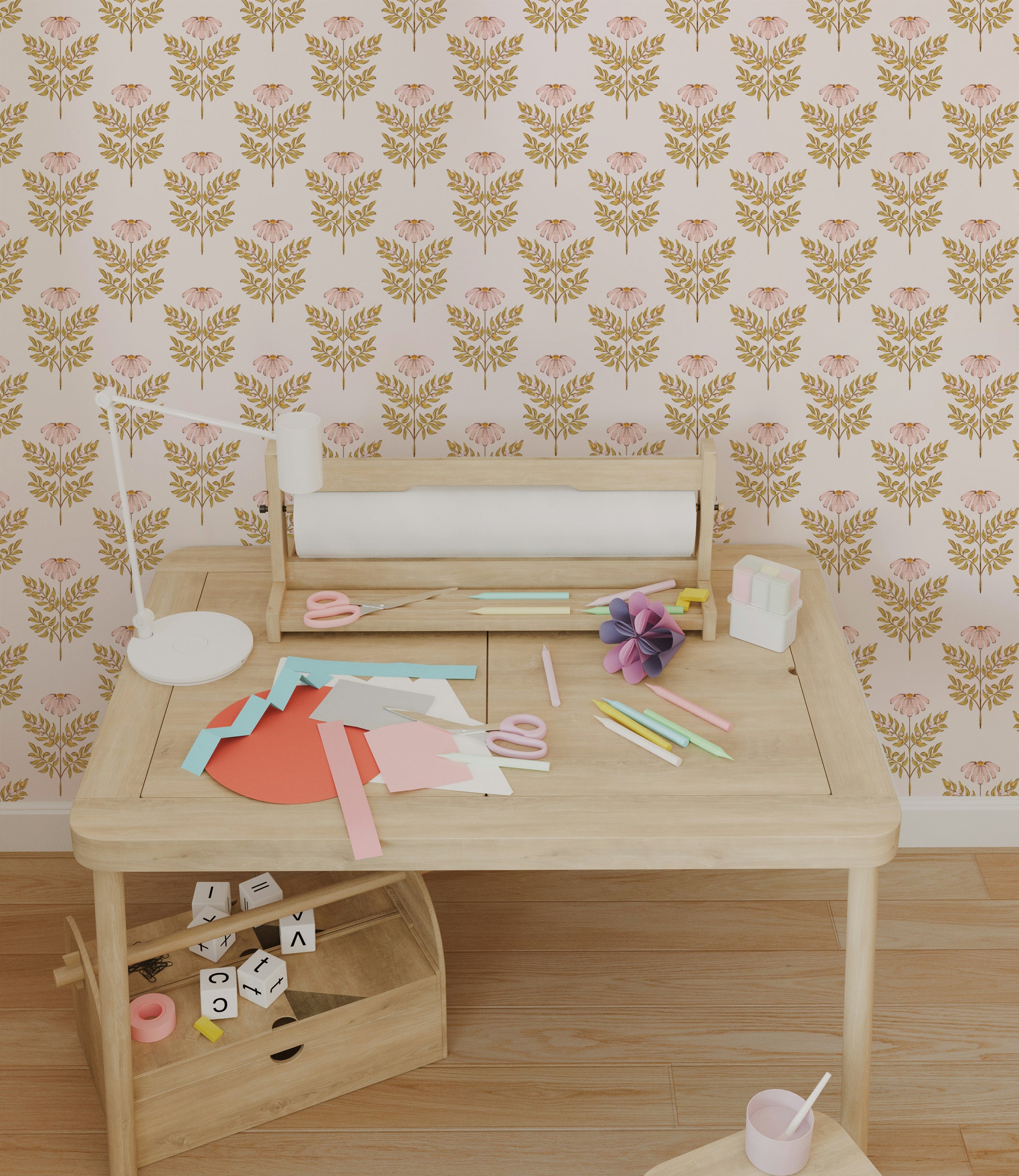 A vibrant and artistic workspace featuring the Ditsy Daisy Wallpaper - Small, adorned with a pattern of small pink daisies and golden foliage against a pale background. The room includes a wooden desk cluttered with craft supplies, emphasizing a creative and playful environment.