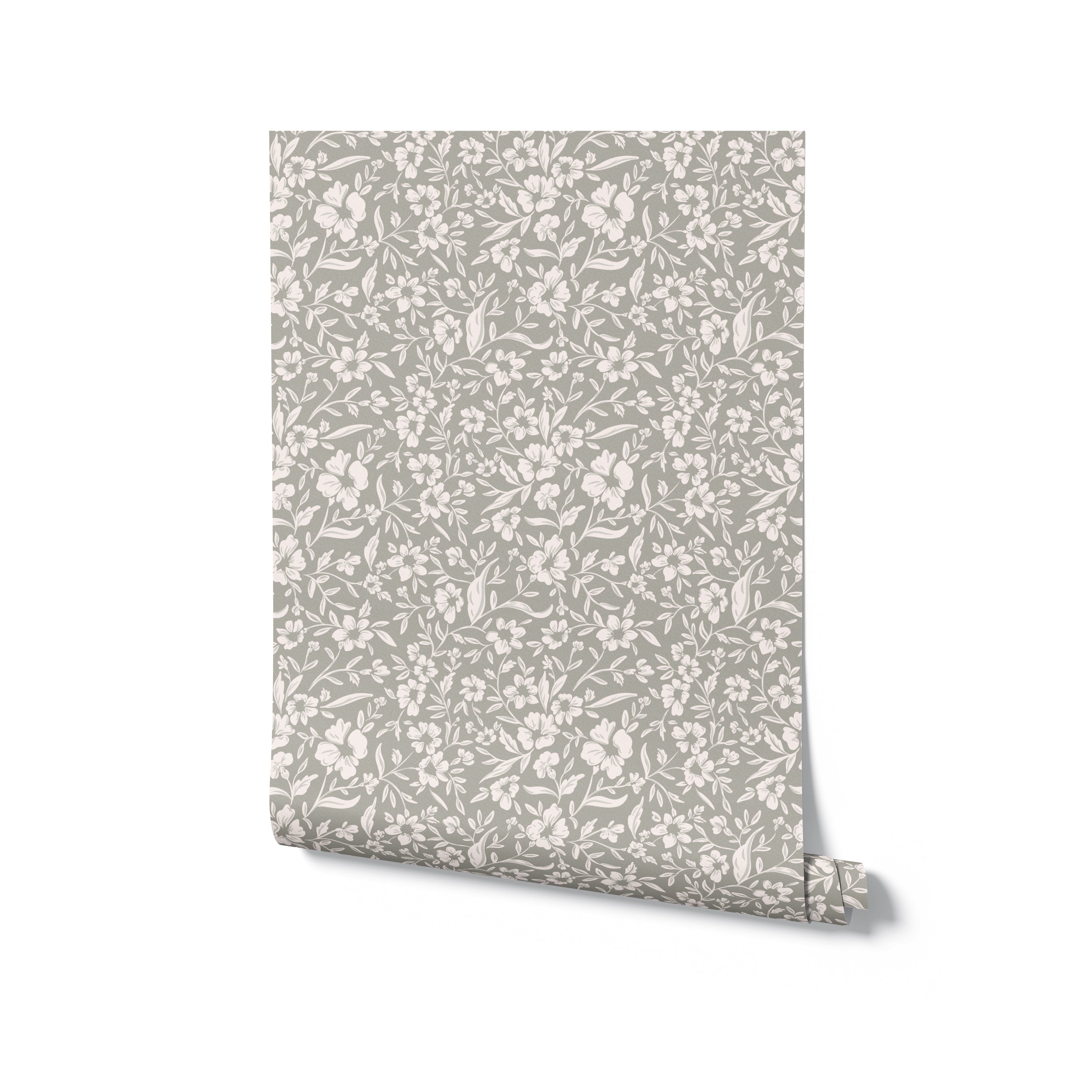 A rolled sample of Soft Meadows Wallpaper highlighting its beautiful and detailed floral pattern in soft white on a light grey background, ideal for adding a gentle, stylish touch to any room.