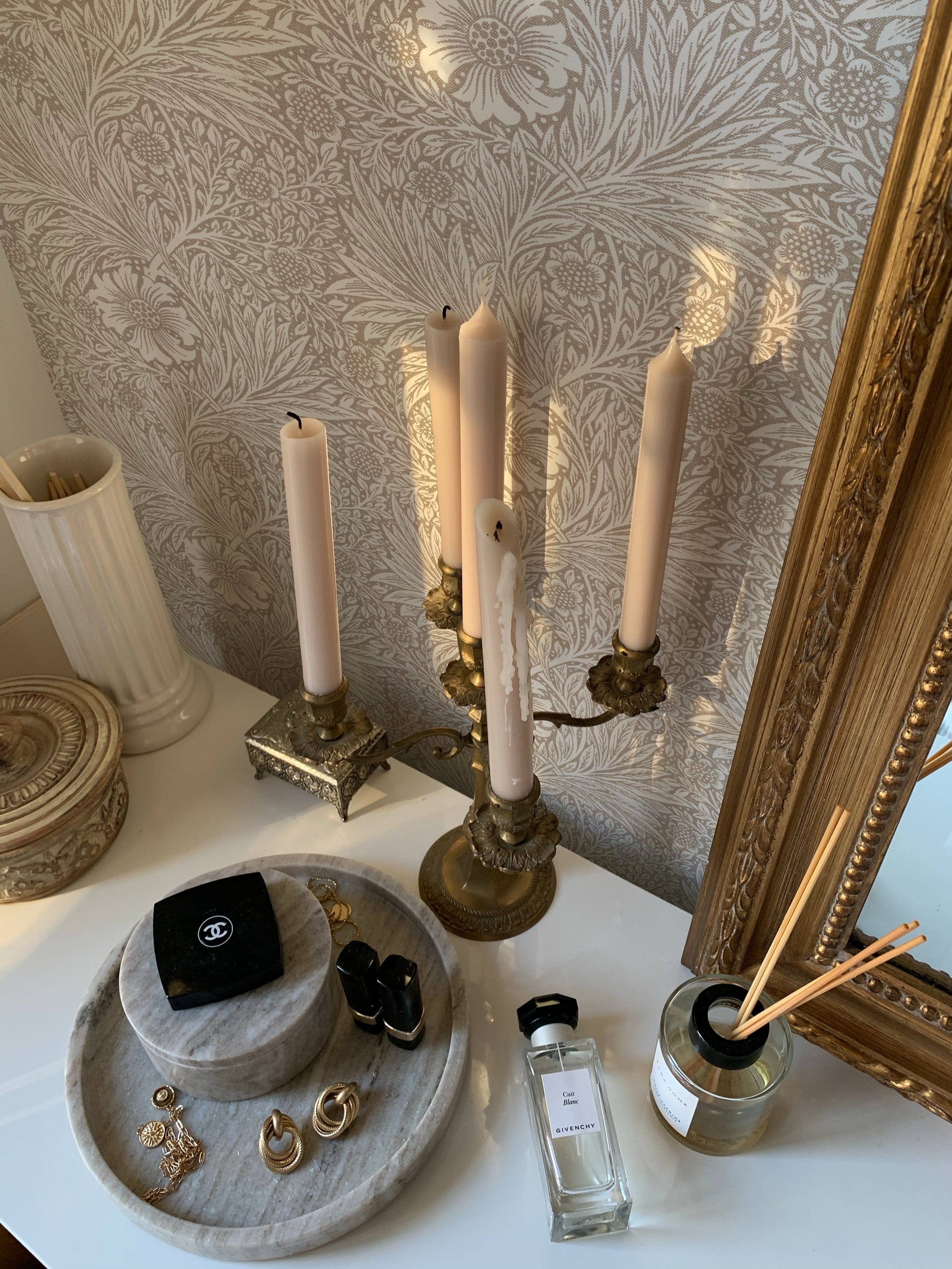 Elegant interior setup with a Timeless Floral Wallpaper featuring intricate beige floral patterns, enhancing the antique look of a gilded mirror and vintage decorations
