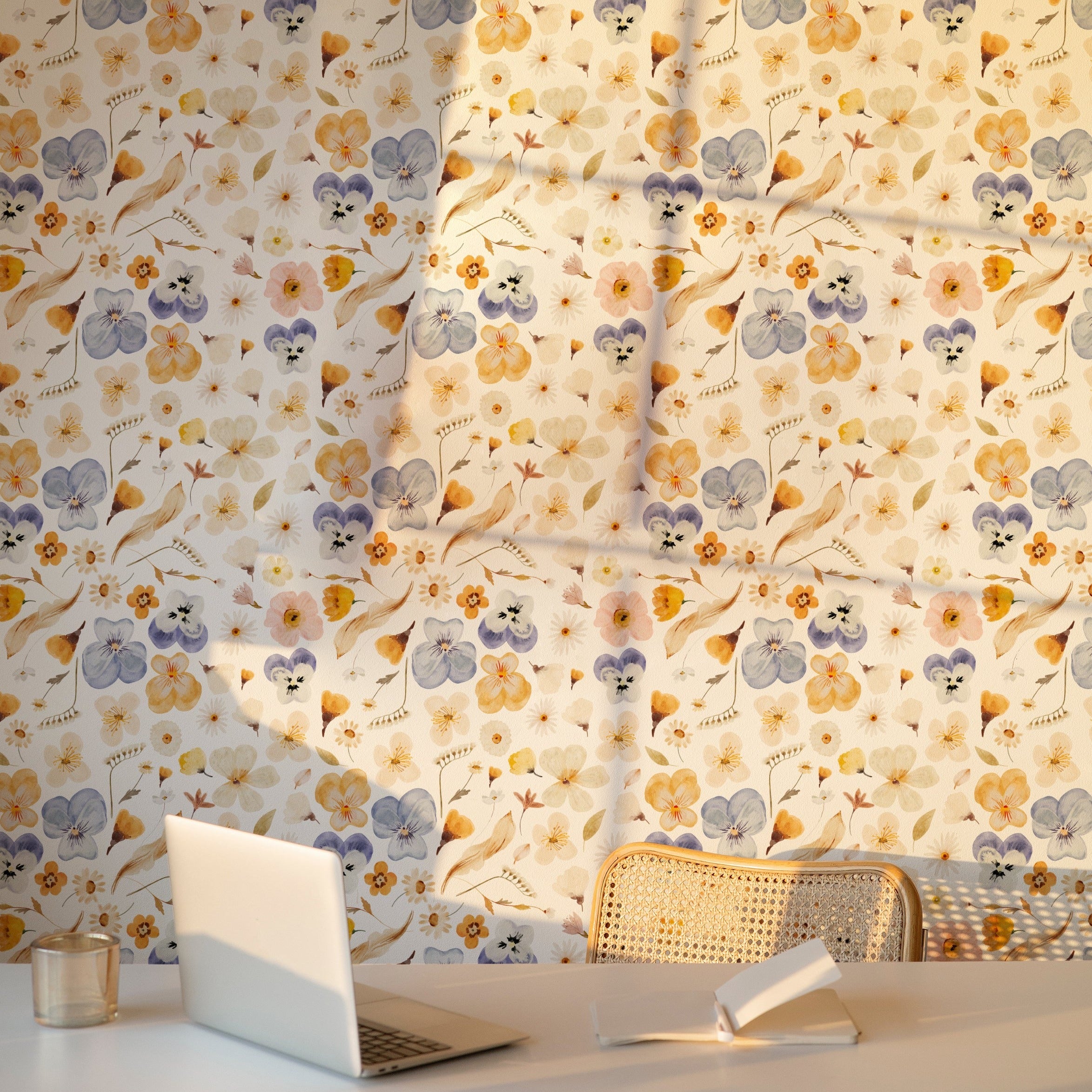 A workspace enhanced by the Blooming Boho Floral Wallpaper, featuring a modern desk with a laptop and a chair against a backdrop of the floral pattern. The wallpaper's lively yet soothing design creates an inspiring and pleasant working environment.