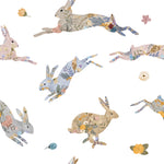 Close-up view of the 'Floral Bunnies Wallpaper,' showcasing its intricate design. Each rabbit is uniquely adorned with a collage of soft floral prints in gentle hues, interspersed with tiny blooms and leaves, giving the wallpaper a delicate and enchanting appearance