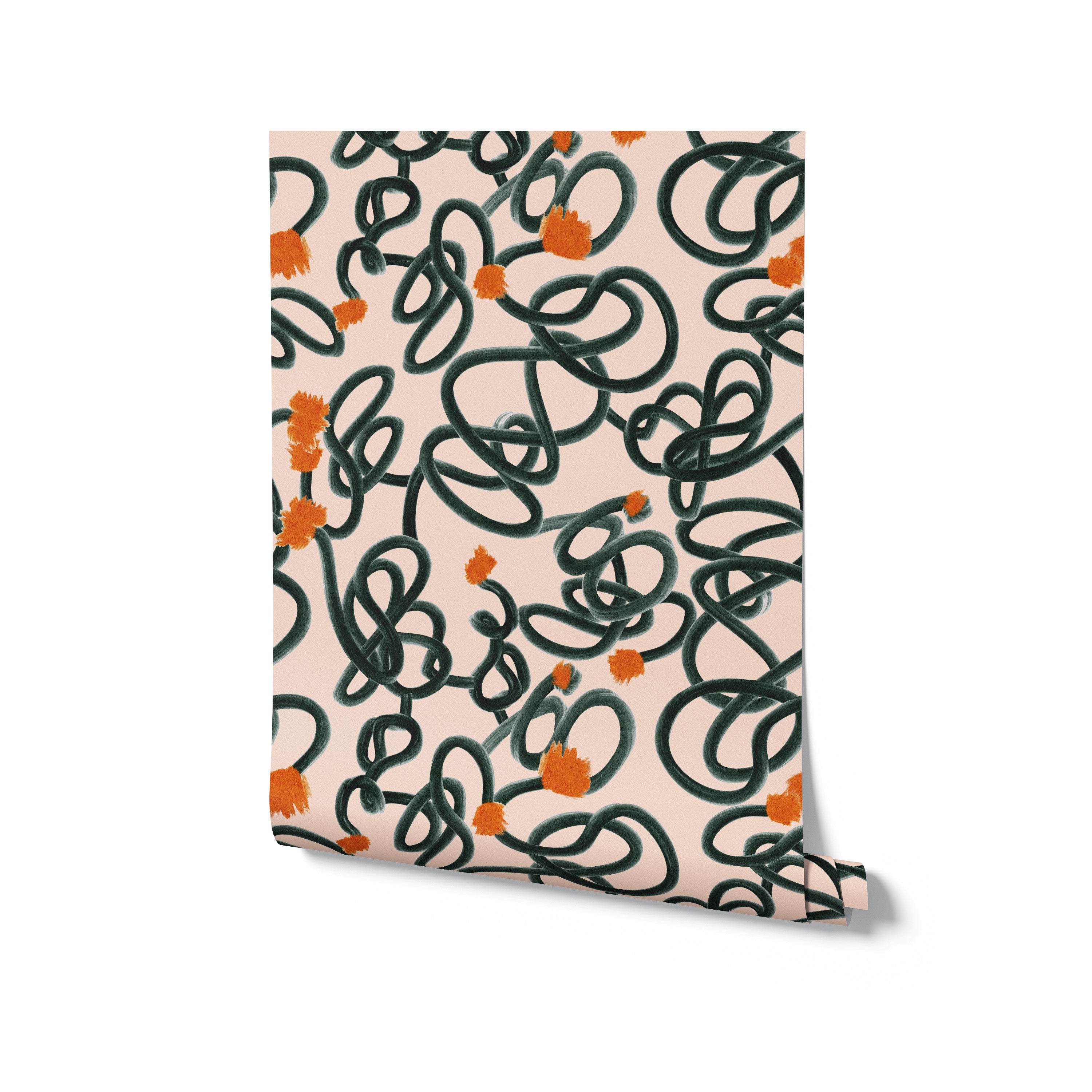 Rolled up view of Abstract Scribble Wallpaper showing off its chaotic yet charming pattern of dark green loops and orange blooms against a peach-colored background, ready to bring a lively and artistic vibe to any interior space.