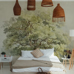 A serene bedroom setting featuring the Boomstudie Vintage Wall Mural, which depicts a lush, detailed painting of a large tree with sprawling branches and green leaves. The mural covers the entire wall behind the bed, complemented by natural wicker lampshades, enhancing the room's tranquil, nature-inspired ambiance.