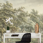 A modern office space is enhanced by a vintage wall mural titled 'Landscape in Eext', showing an expansive pastoral scene with tall trees and a lush green setting, complete with a white desk, black chair, and elegant orchid in the foreground.