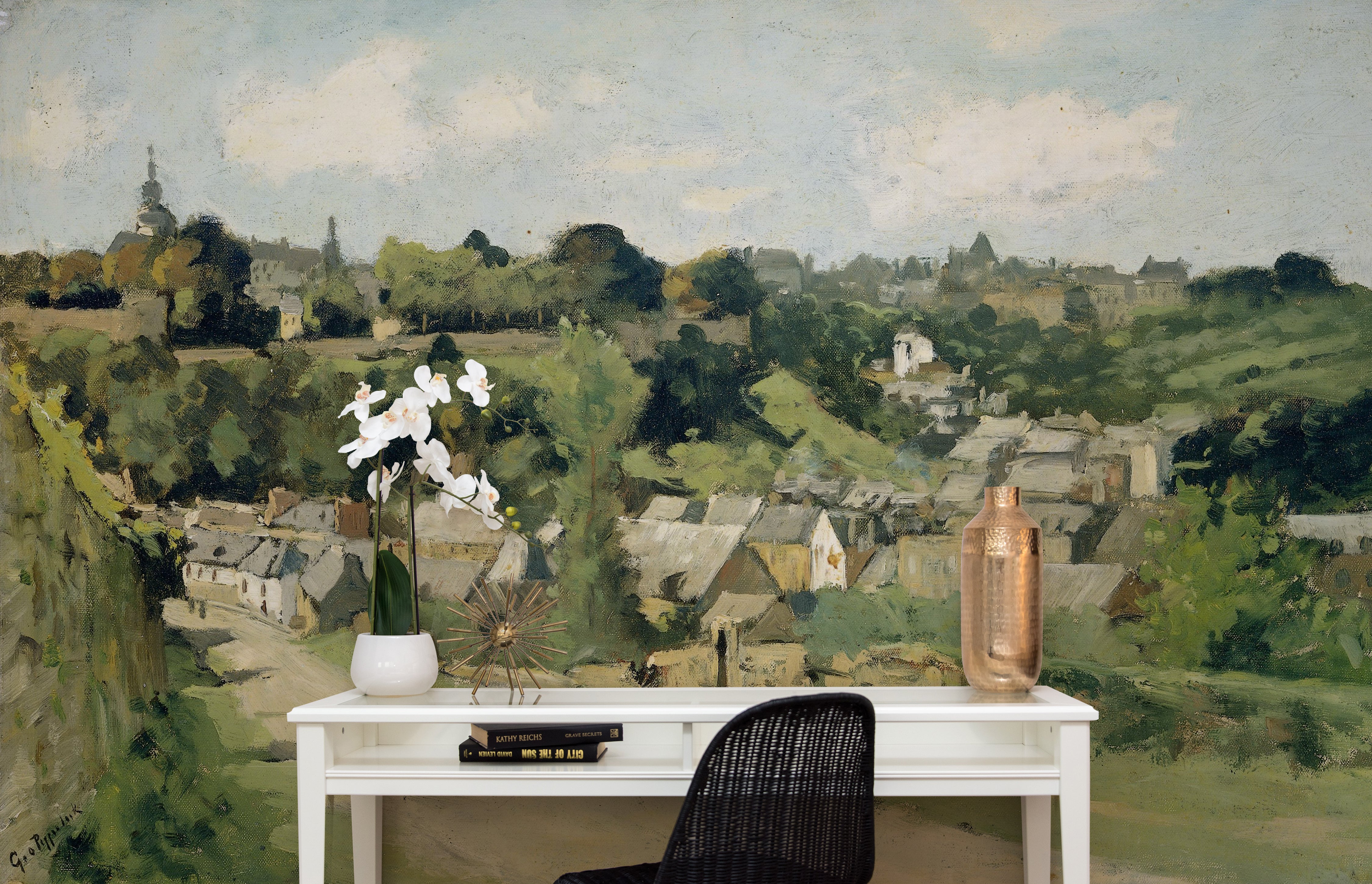 Elegant office setup featuring a 'Views - Vintage Wall Mural' that depicts a panoramic rural landscape. The detailed artwork, displayed behind a simple white desk, contrasts beautifully with modern decor elements like a sleek black chair and a decorative copper vase.