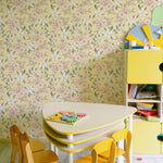 A vibrant children's playroom decorated with the Sunny Nursery Wallpaper, featuring a playful floral pattern on a yellow background, complemented by a kid-sized table and chairs, enhancing the space's lively and inviting atmosphere.