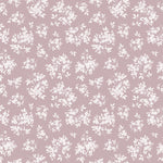 A seamless pattern of the Vintage Garden Floral Wallpaper, displaying clusters of delicate white flowers and foliage against a soft mauve background. The floral design is detailed and dense, giving a lush, full appearance, and invokes a sense of timeless elegance reminiscent of vintage botanical illustrations.