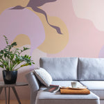 A contemporary living room featuring the Contemporary Art - Abstract Wall Mural. The mural's abstract shapes in calming colors provide a striking backdrop, complementing the modern furniture and overall minimalist decor.
