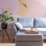 A contemporary living room featuring the Contemporary Art - Abstract Wall Mural. The mural's abstract shapes in calming colors provide a striking backdrop, complementing the modern furniture and overall minimalist decor.