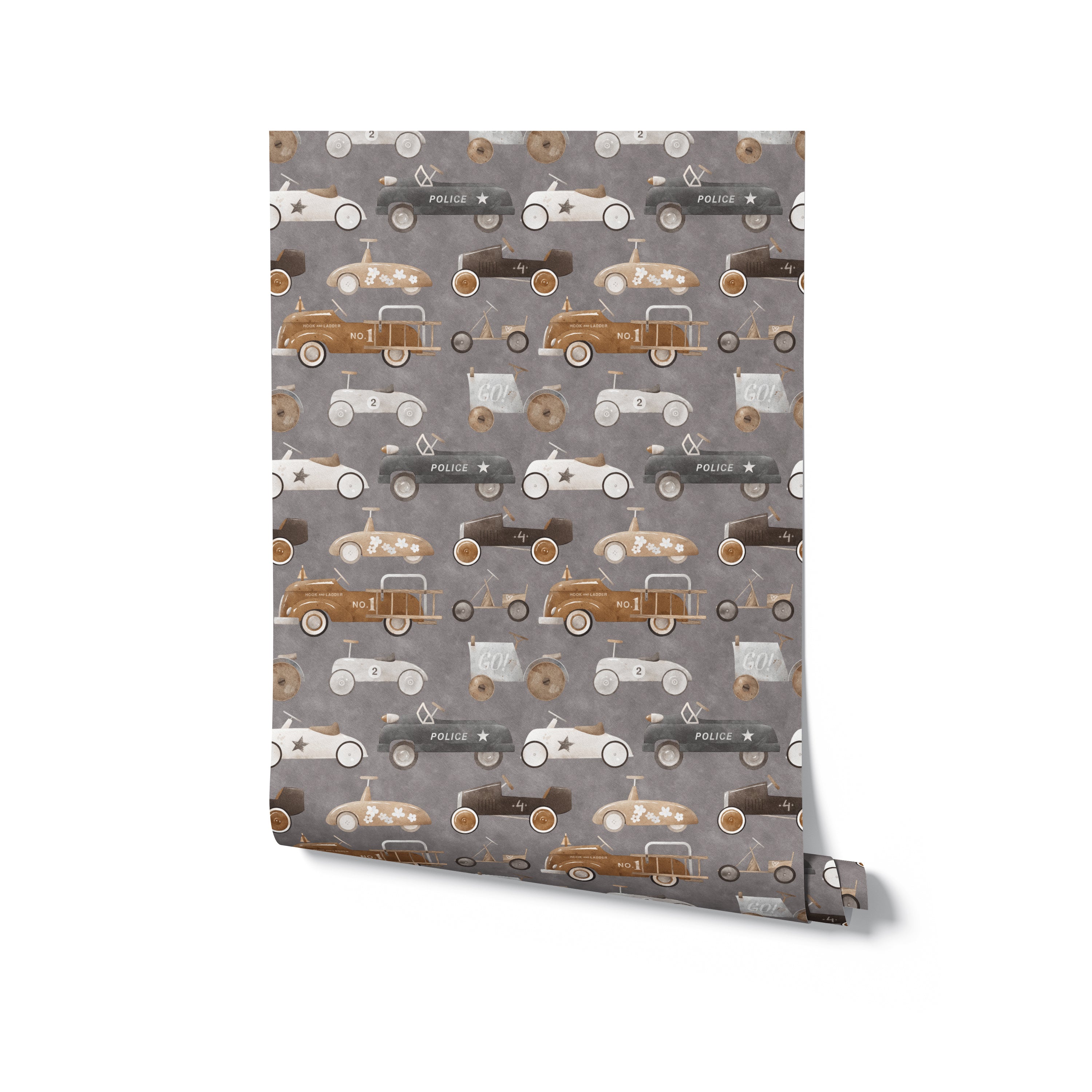 A flat lay view of a single roll of Retro Wheels Wallpaper. The wallpaper features a variety of vintage car illustrations in a seamless pattern, highlighting the detailed artwork and retro style in shades of brown, gray, and white.