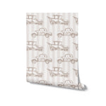 A single roll of Antique Auto Wallpaper, unrolled to display its charming design of old-fashioned cars on a beige striped background.
