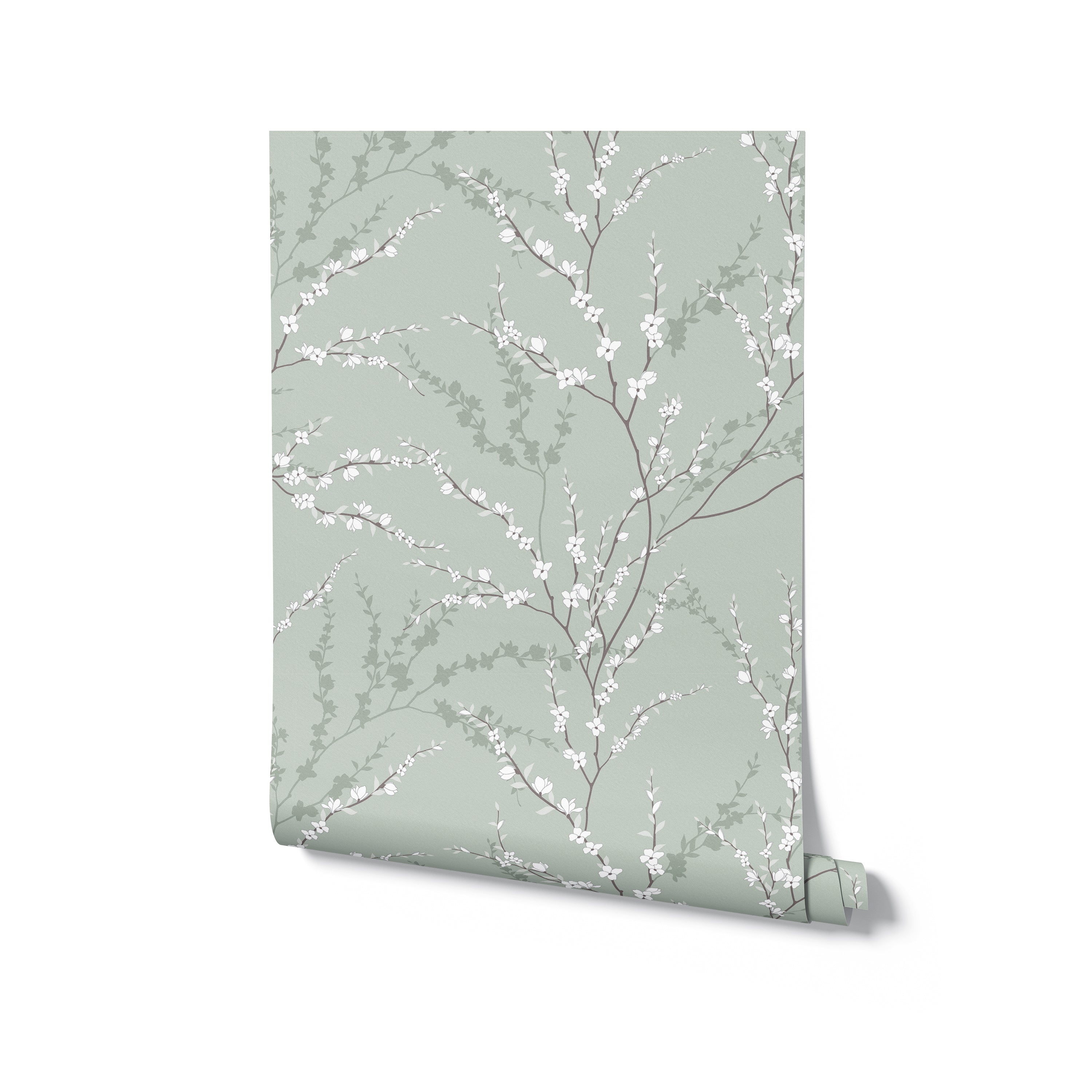 A roll of the Enchanted Blossoms Wallpaper partially unfurled, revealing the wallpaper's full pattern of graceful white flowers and leaves set against a gentle green, ready to transform any space with its enchanting design.