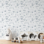A children's play area with a storage unit for toys and a fabric bag shaped like a raccoon. The background features Speedway Adventures Wallpaper with various vehicle and road-themed illustrations in light gray on a white background, enhancing the playful and imaginative space