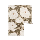 Roll of White Peony Wallpaper displaying the detailed floral pattern with large white peony flowers and lush green leaves on a soft beige background. The sophisticated design is perfect for adding a touch of elegance to any room.