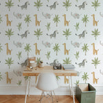 A child-friendly workspace is brought to life with Jungle Animal Nursery Wallpaper featuring playful giraffes, elephants, zebras, and palm leaves, creating a delightful and stimulating environment.